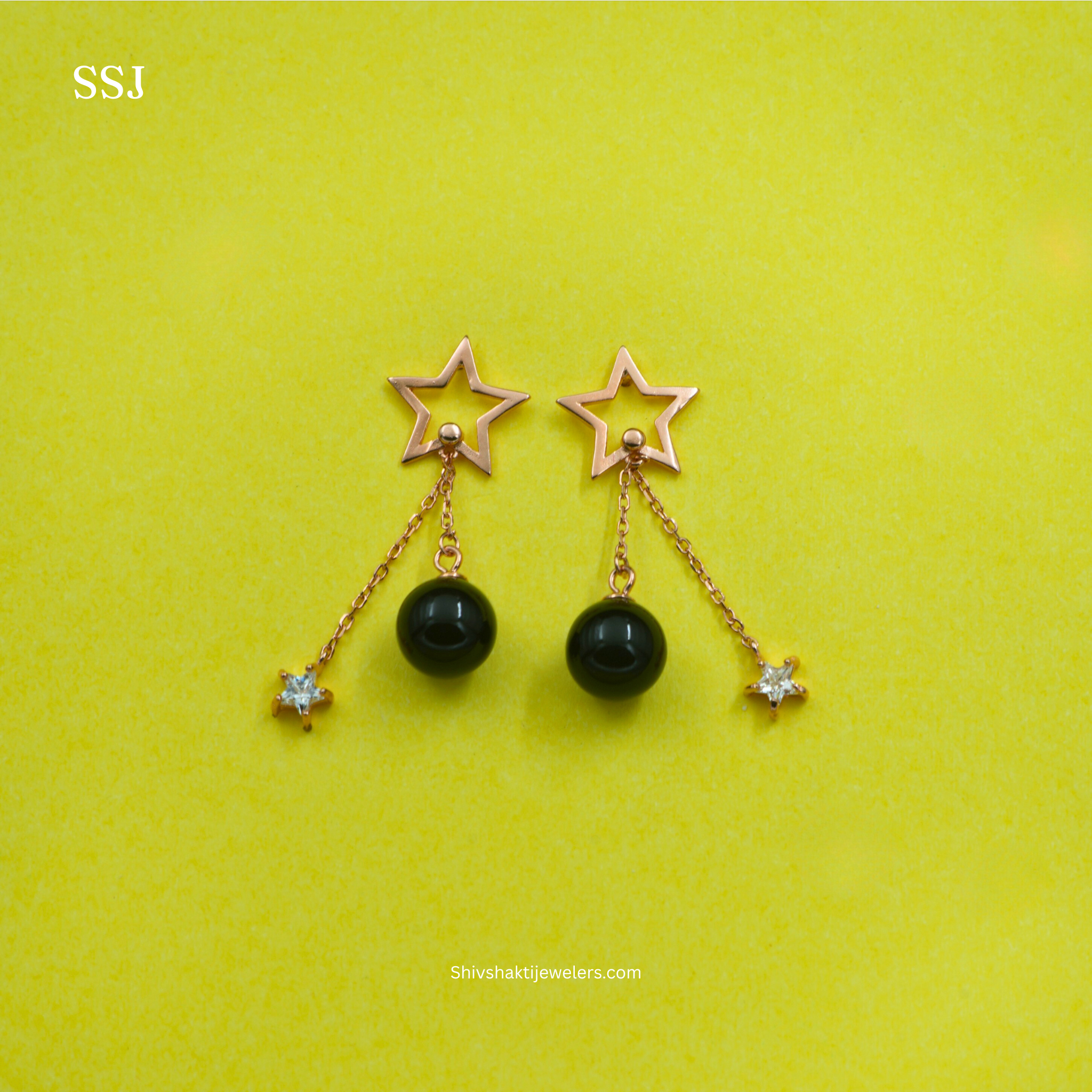 Star-shaped earrings with black beads on a yellow background