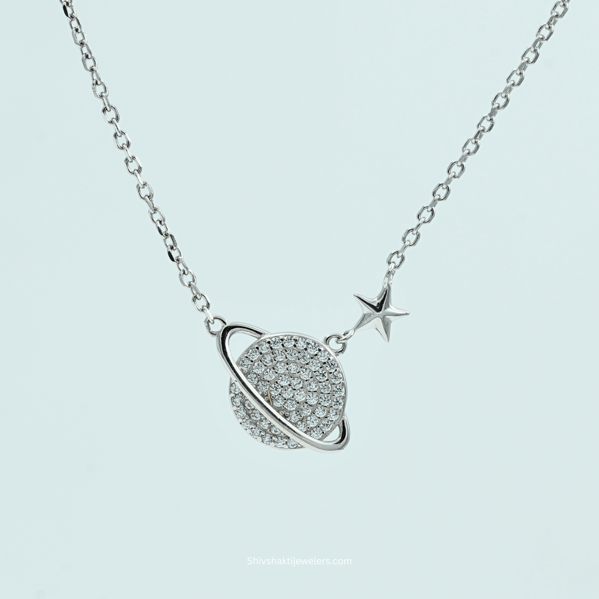 Flatlay view of 925 Silver Saturn & Star Pendant Necklace with CZ stones