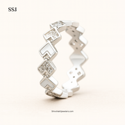 Silver ring with diamond-like stones on a white background