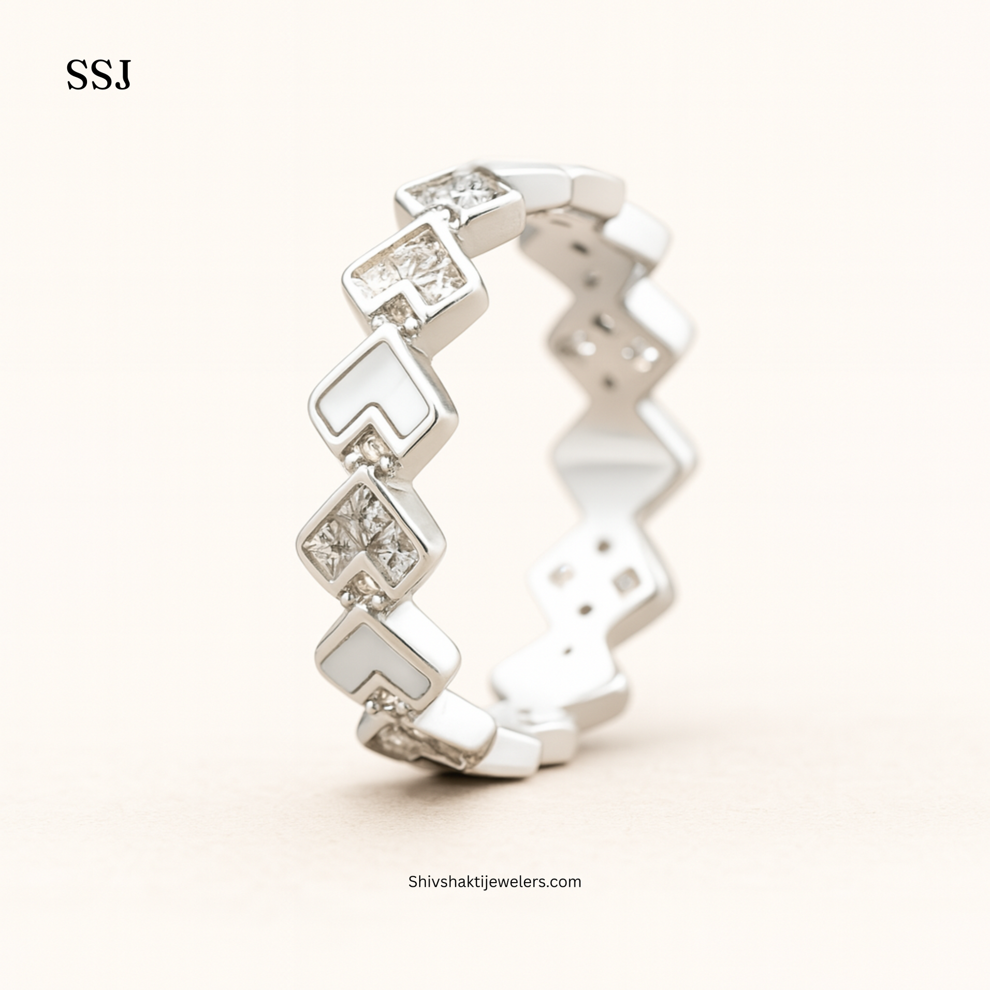 Silver ring with diamond-like stones on a white background