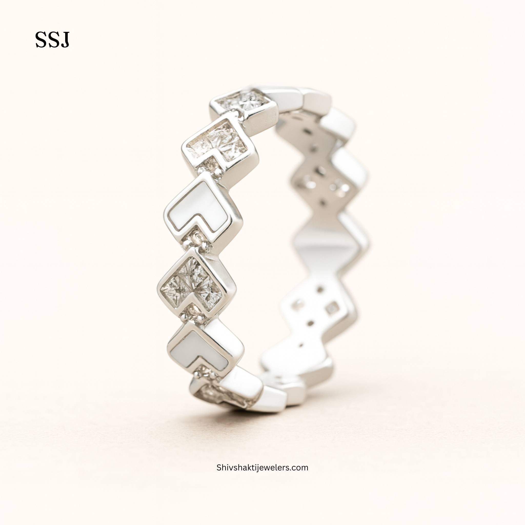 Silver ring with diamond-like stones on a white background