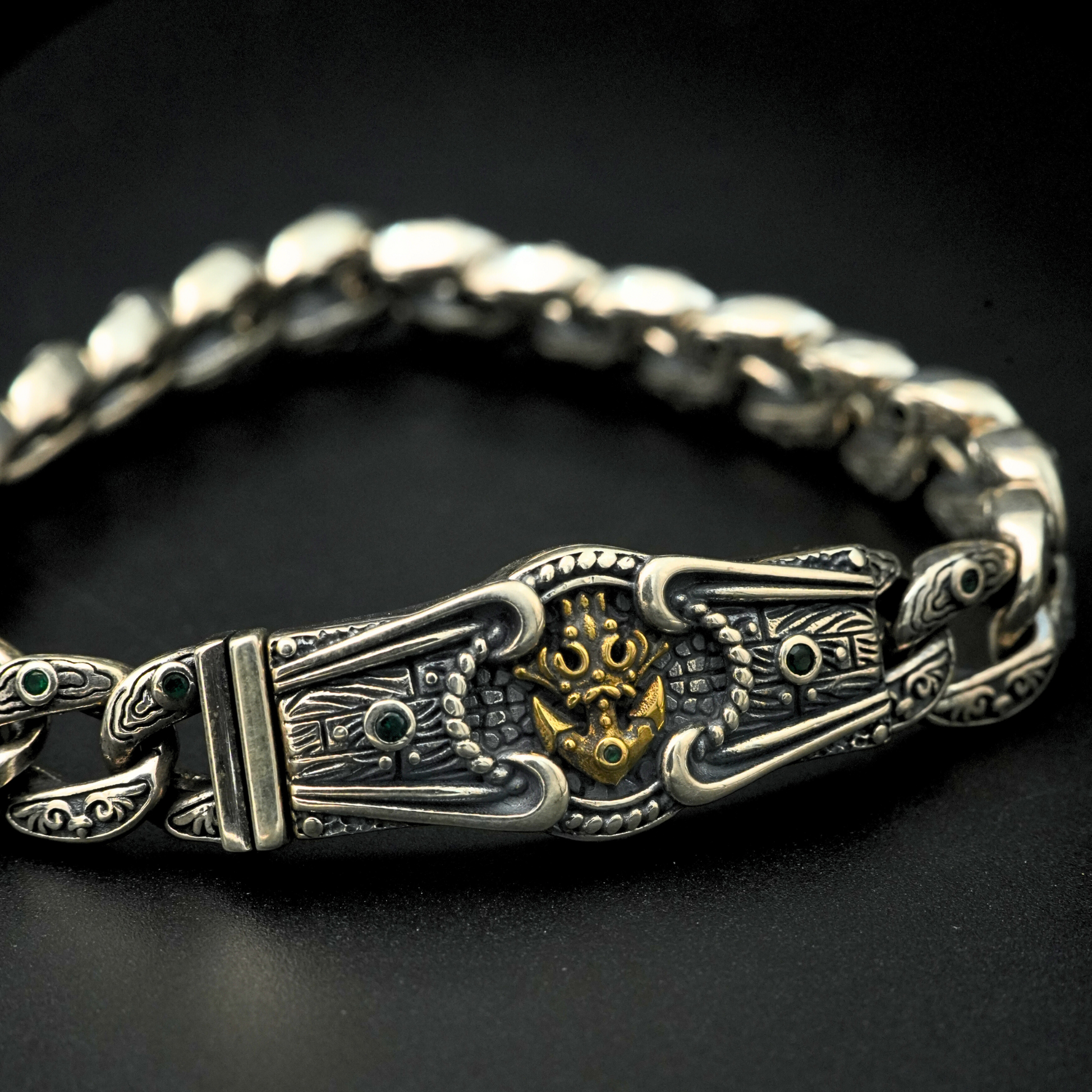 Detailed lion head clasp with oxidized antique finish and green stones