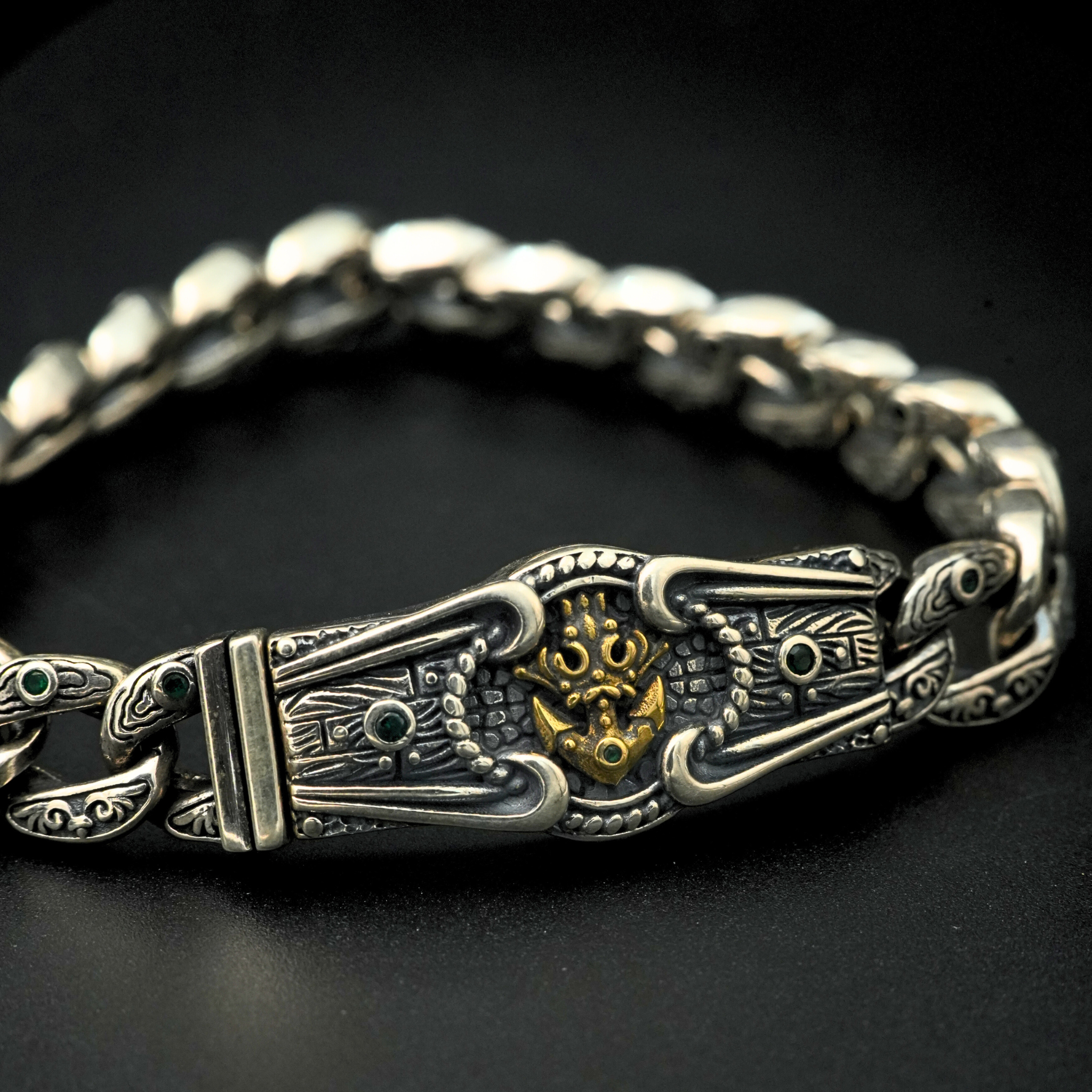 Detailed lion head clasp with oxidized antique finish and green stones