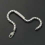 Silver bracelet on a dark gray background