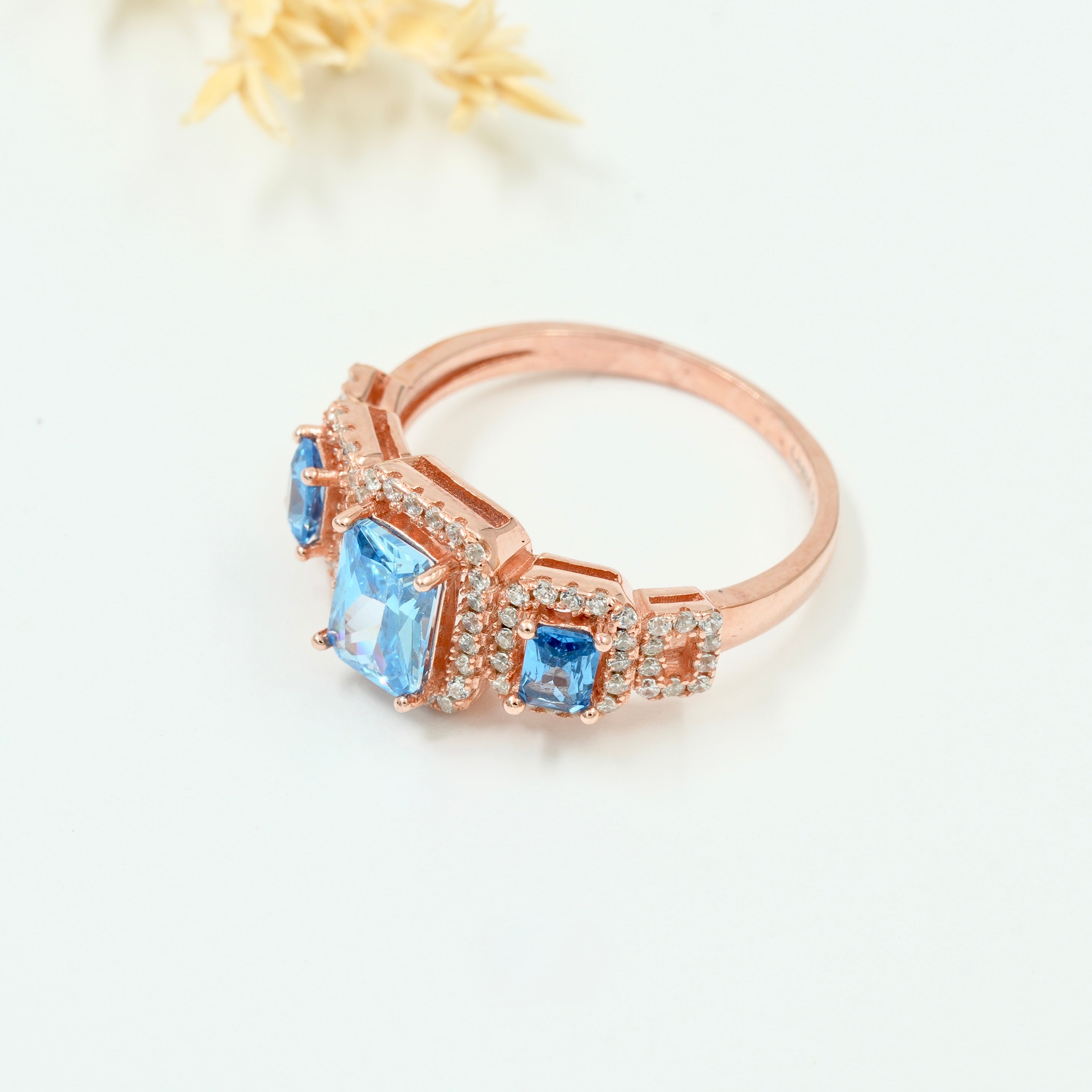 Rose Gold Plated 925 Silver Triple Stone Ring with American Diamond Halo – Available in Blue, Yellow & Peach