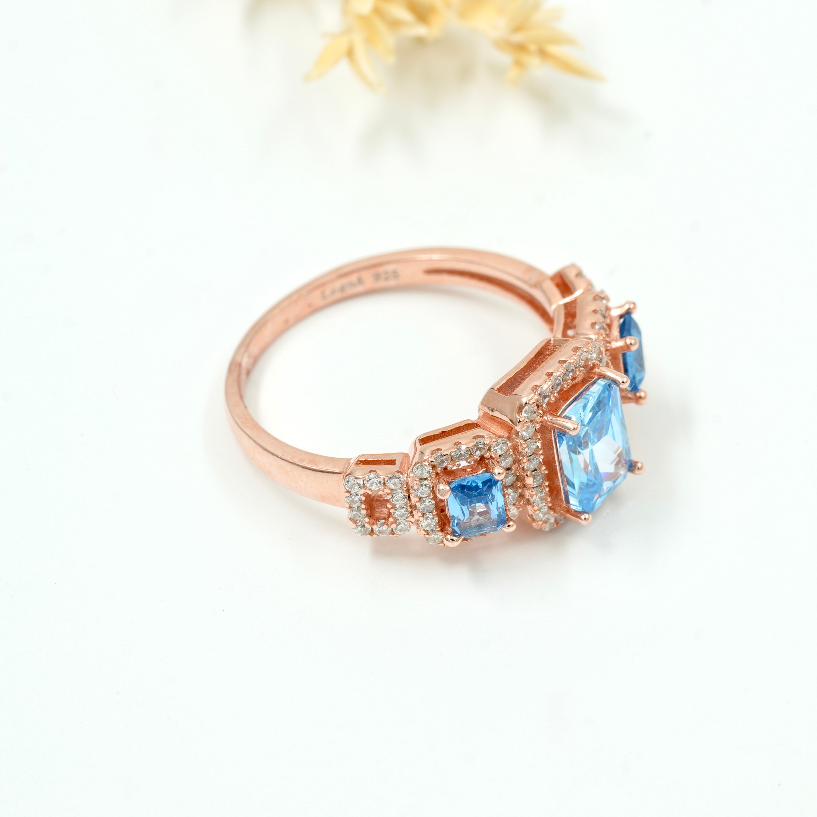 Rose Gold Plated 925 Silver Triple Stone Ring with American Diamond Halo – Available in Blue, Yellow & Peach
